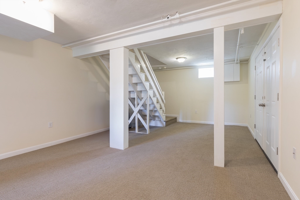 59 Florence Road Waltham, MA 02453 - Photo 16 of 20 a view of an empty room with stairs