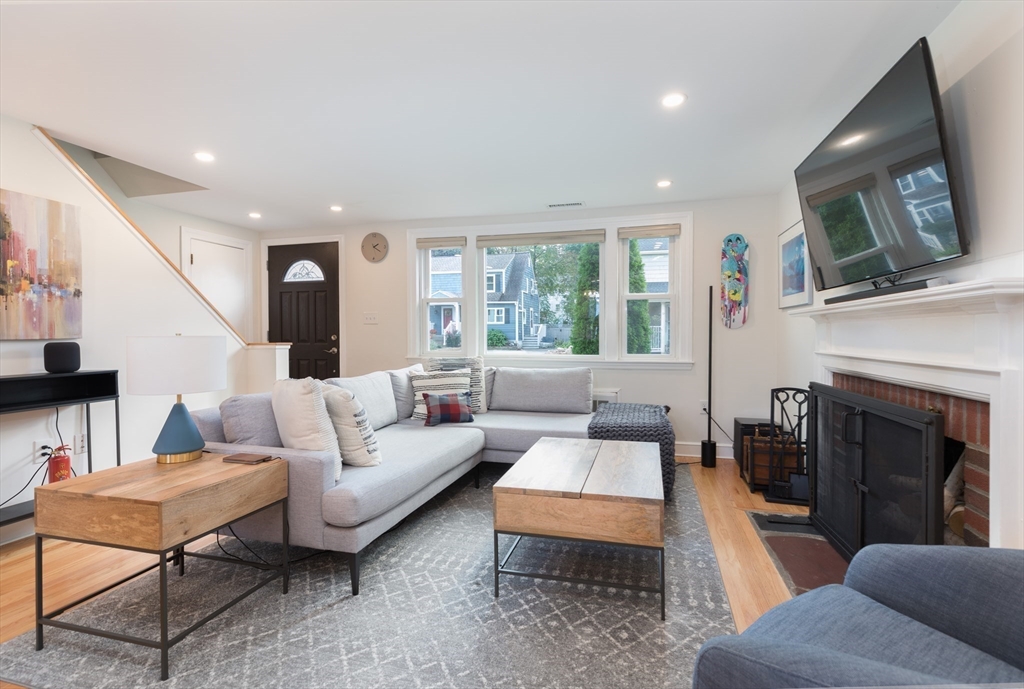 59 Florence Road Waltham, MA 02453 - Photo 6 of 20 a living room with furniture a flat screen tv and a fireplace
