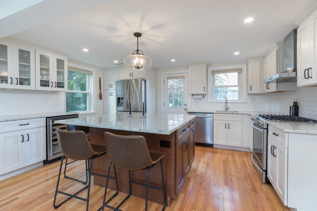 59 Florence Road Waltham, MA 02453 - Photo 7 of 20 a kitchen with stainless steel appliances granite countertop wooden floor a dining table chairs and sink