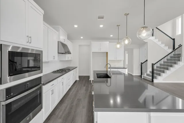 a large bathroom with a large mirror vanity and shower