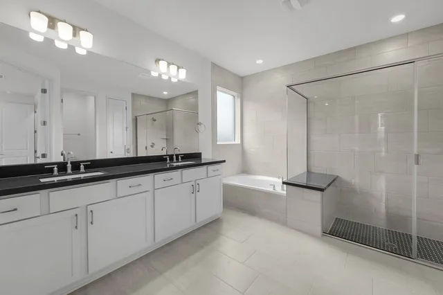 a bathroom with a sink toilet vanity and shower