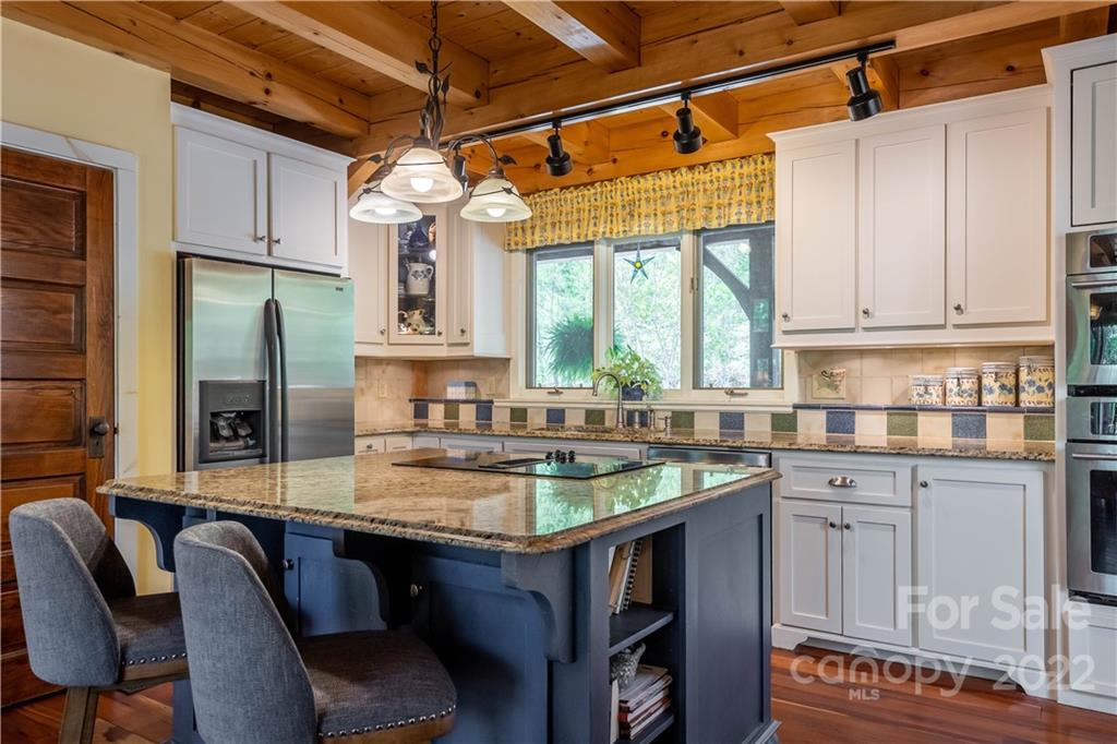 1553 Zacks Fork Road Lenoir, NC 28645 - Photo 12 of 48 a kitchen with a table chairs window and cabinets