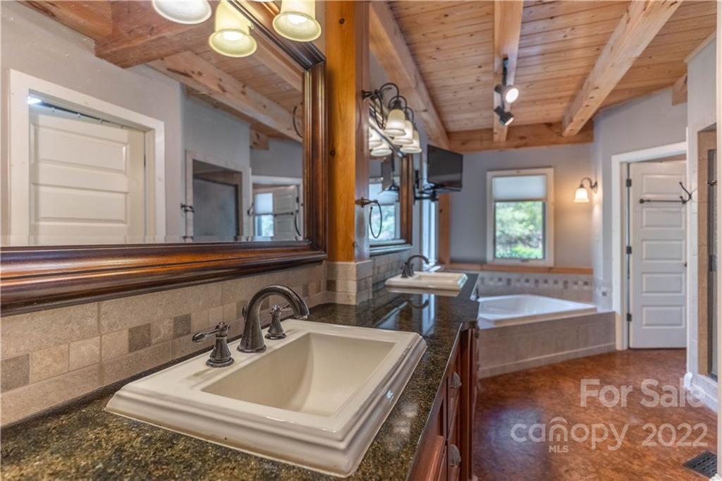 1553 Zacks Fork Road Lenoir, NC 28645 - Photo 18 of 48 a bathroom with a sink and a bathtub