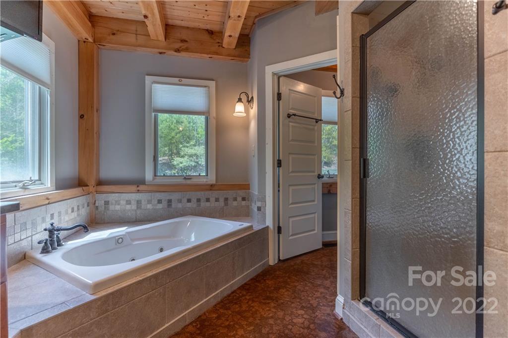 1553 Zacks Fork Road Lenoir, NC 28645 - Photo 19 of 48 a bath tub sitting next to a bathroom sink