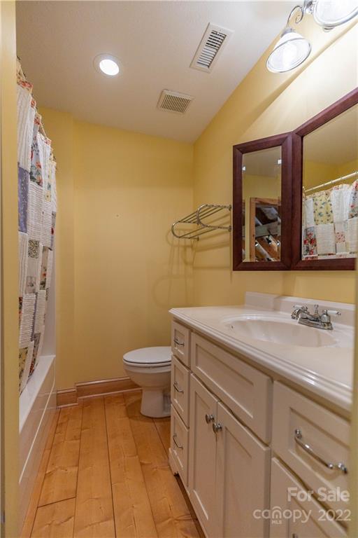 1553 Zacks Fork Road Lenoir, NC 28645 - Photo 28 of 48 a bathroom with a toilet sink and mirror