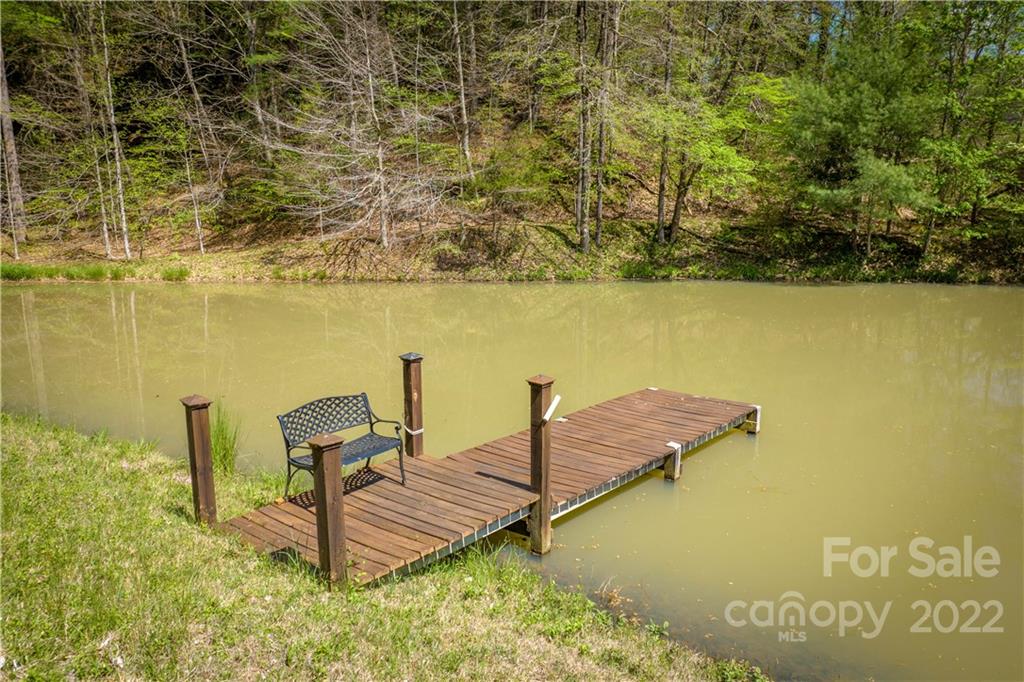 1553 Zacks Fork Road Lenoir, NC 28645 - Photo 36 of 48 a view of a lake with table and chairs