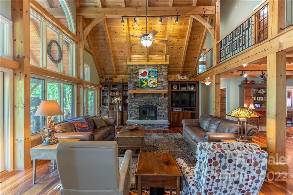 1553 Zacks Fork Road Lenoir, NC 28645 - Photo 4 of 48 a living room with furniture a fireplace and a chandelier