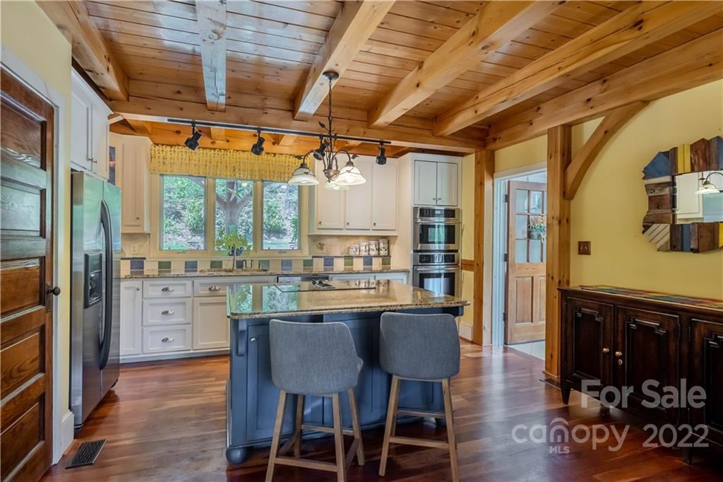 1553 Zacks Fork Road Lenoir, NC 28645 - Photo 10 of 48 a dining room with stainless steel appliances granite countertop furniture wooden floor and a kitchen view