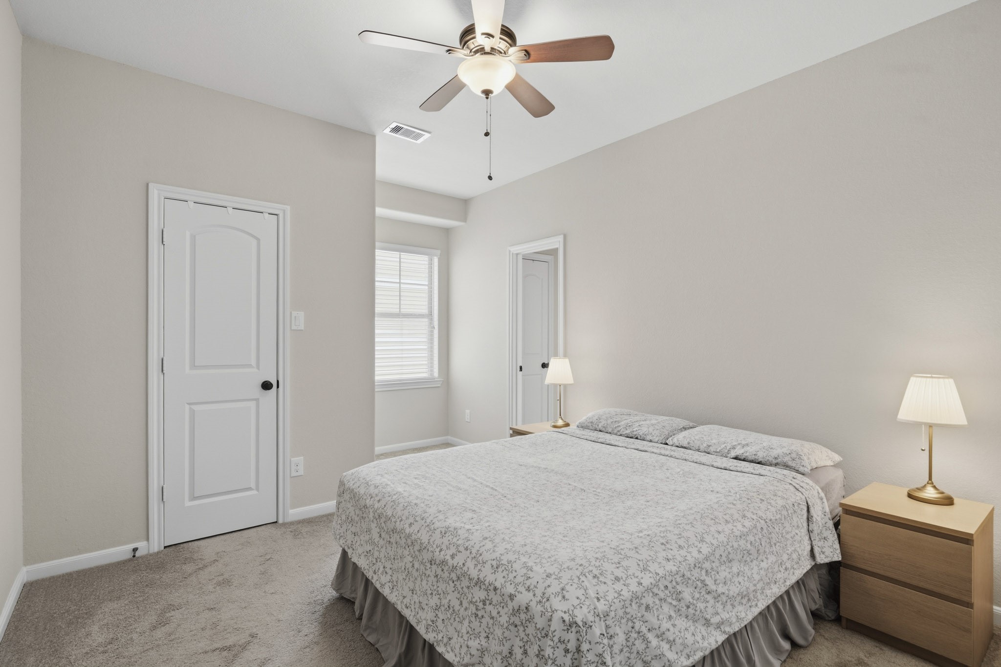 12115 San Luca Street Richmond, TX 77406 - Photo 27 of 44 Designed with comfort in mind, this inviting bedroom offers a spacious layout and easy access to nearby bathrooms and additional living spaces.