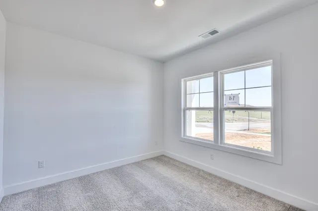 an empty room with closet and mirror