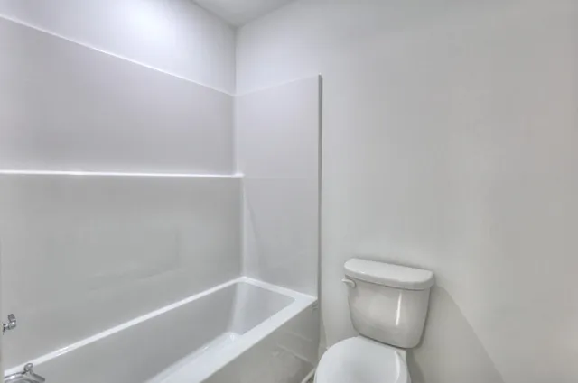 an empty room with a empty space and windows