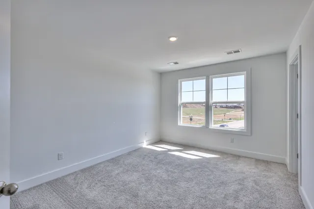 a view of an empty room and closet area