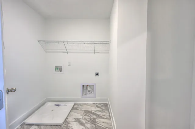 a view of a hallway with bathroom and bathroom