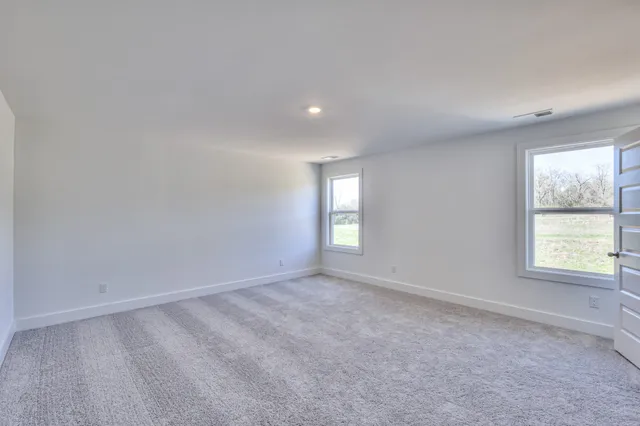 an empty room with closet and a bathroom