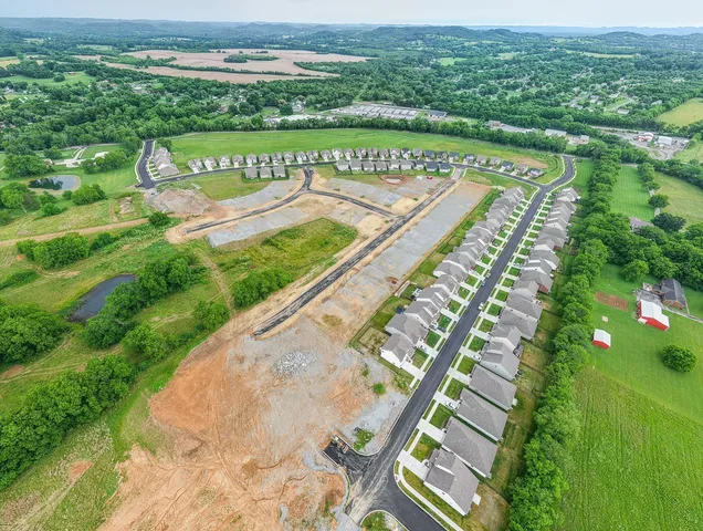 an aerial view of a house with yard