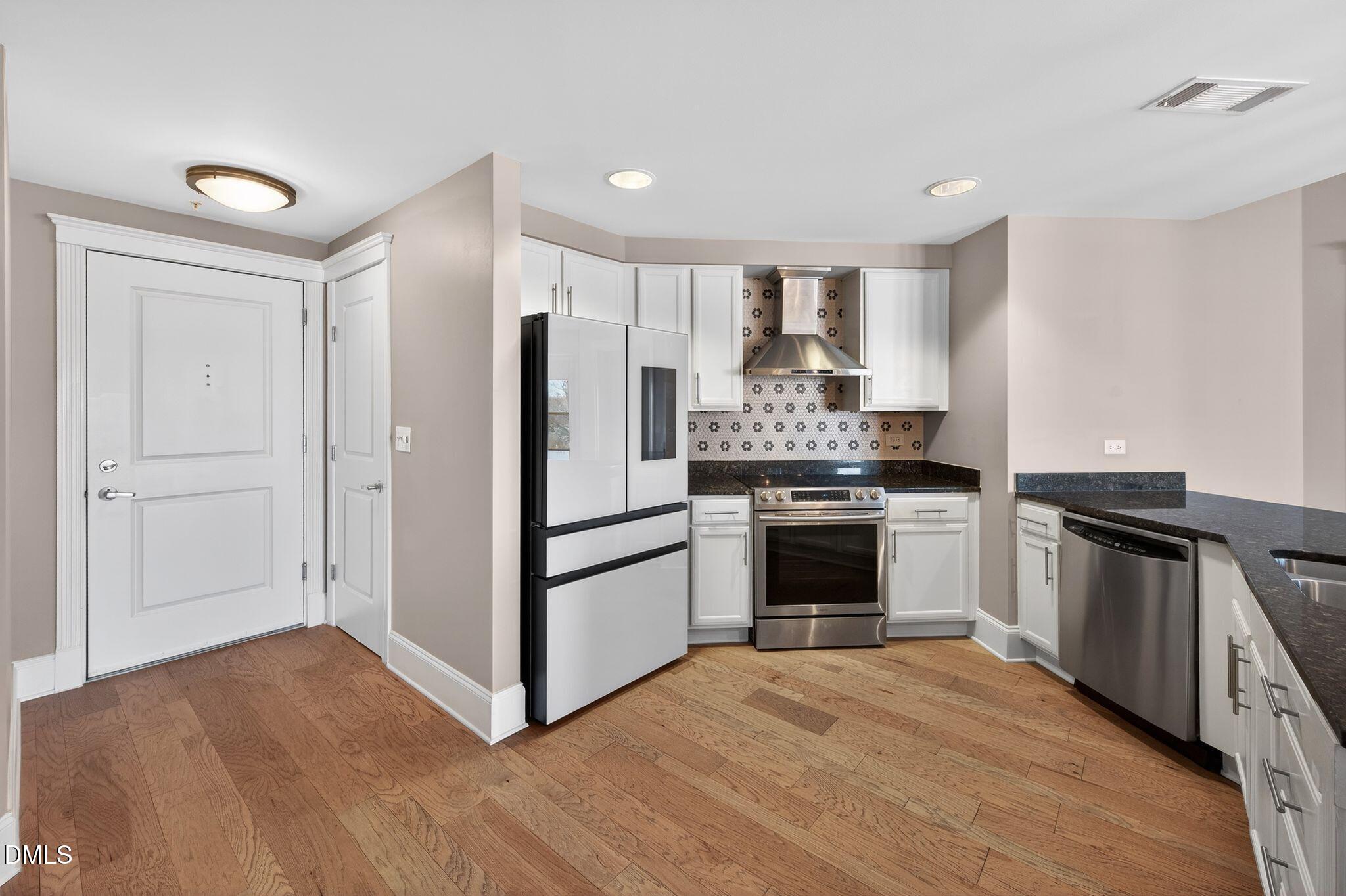 a kitchen with granite countertop a stove and a refrigerator