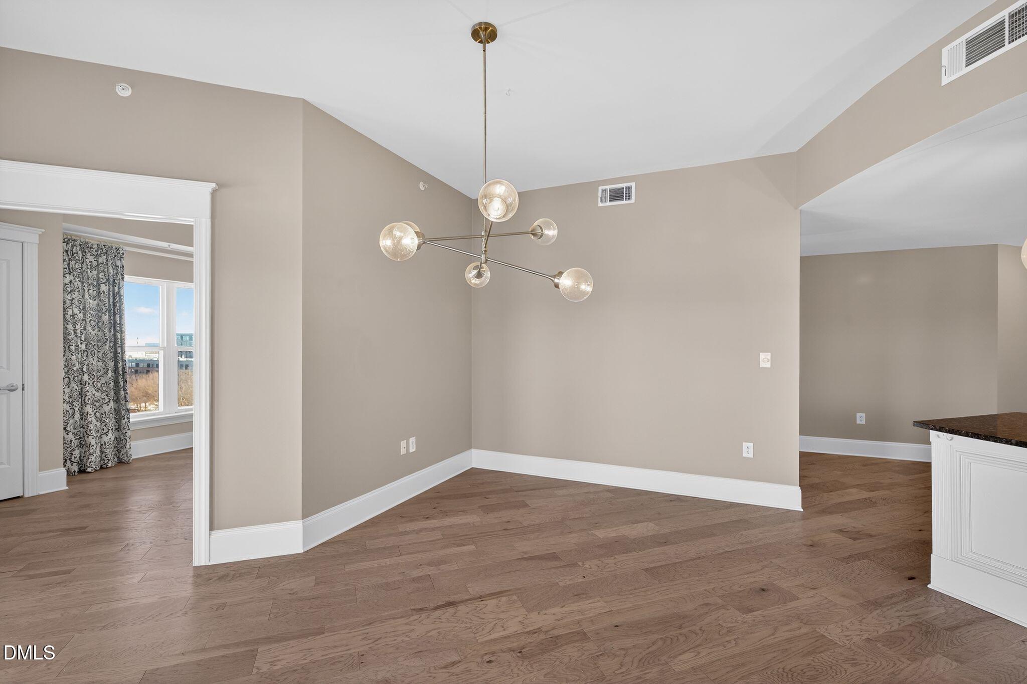 222 Glenwood Avenue, Unit 605 Raleigh, NC 27603 - Photo 11 of 60 wooden floor in an empty room with a window