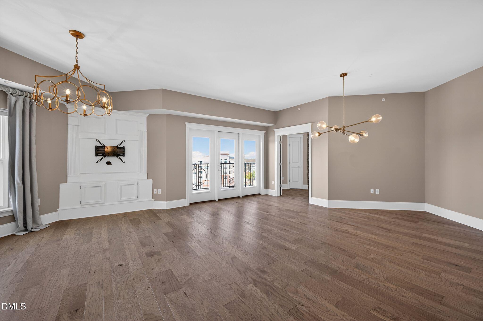 222 Glenwood Avenue, Unit 605 Raleigh, NC 27603 - Photo 12 of 60 a view of an empty room with window and wooden floor