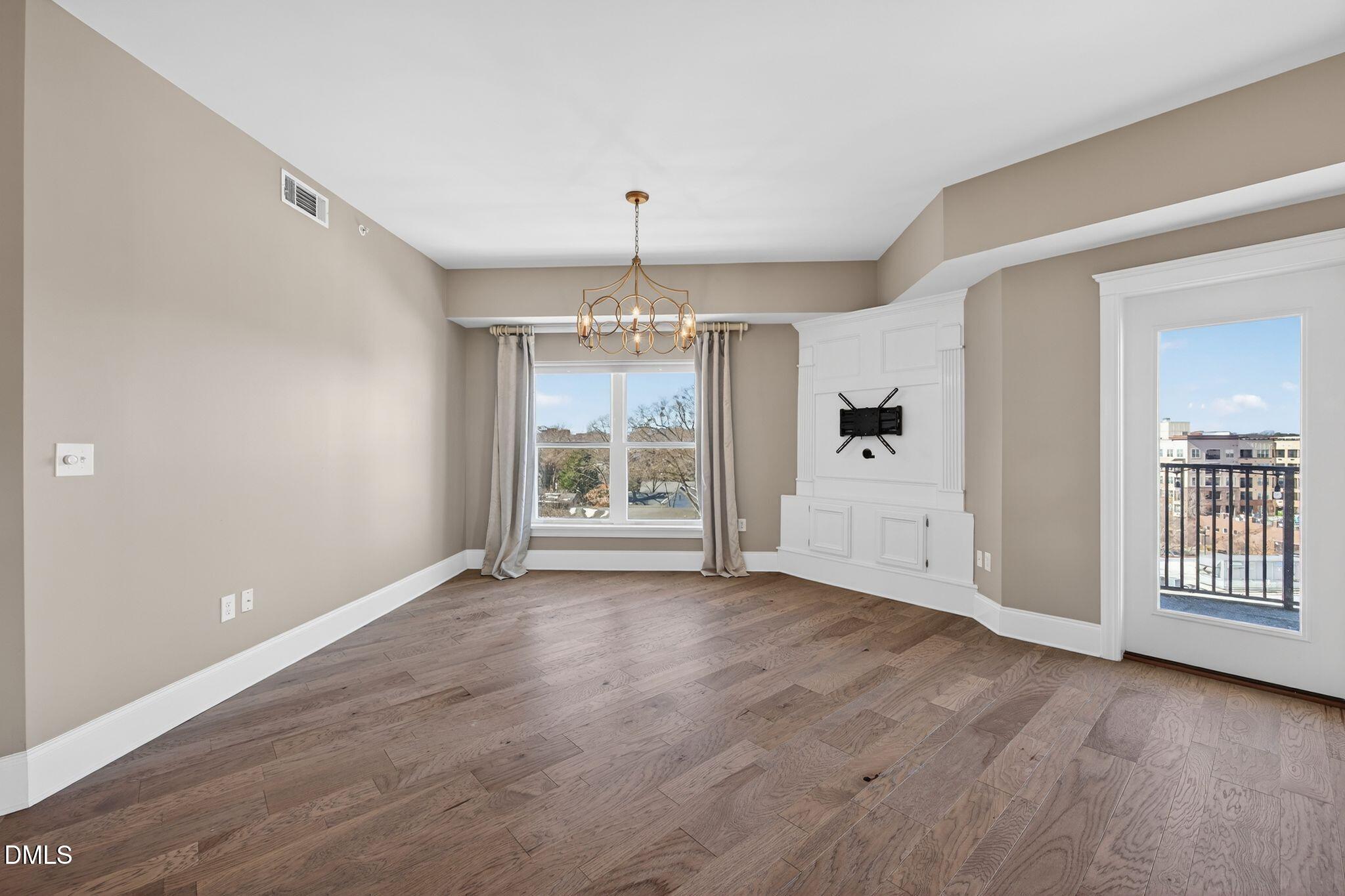 222 Glenwood Avenue, Unit 605 Raleigh, NC 27603 - Photo 15 of 60 wooden floor in an empty room with a window