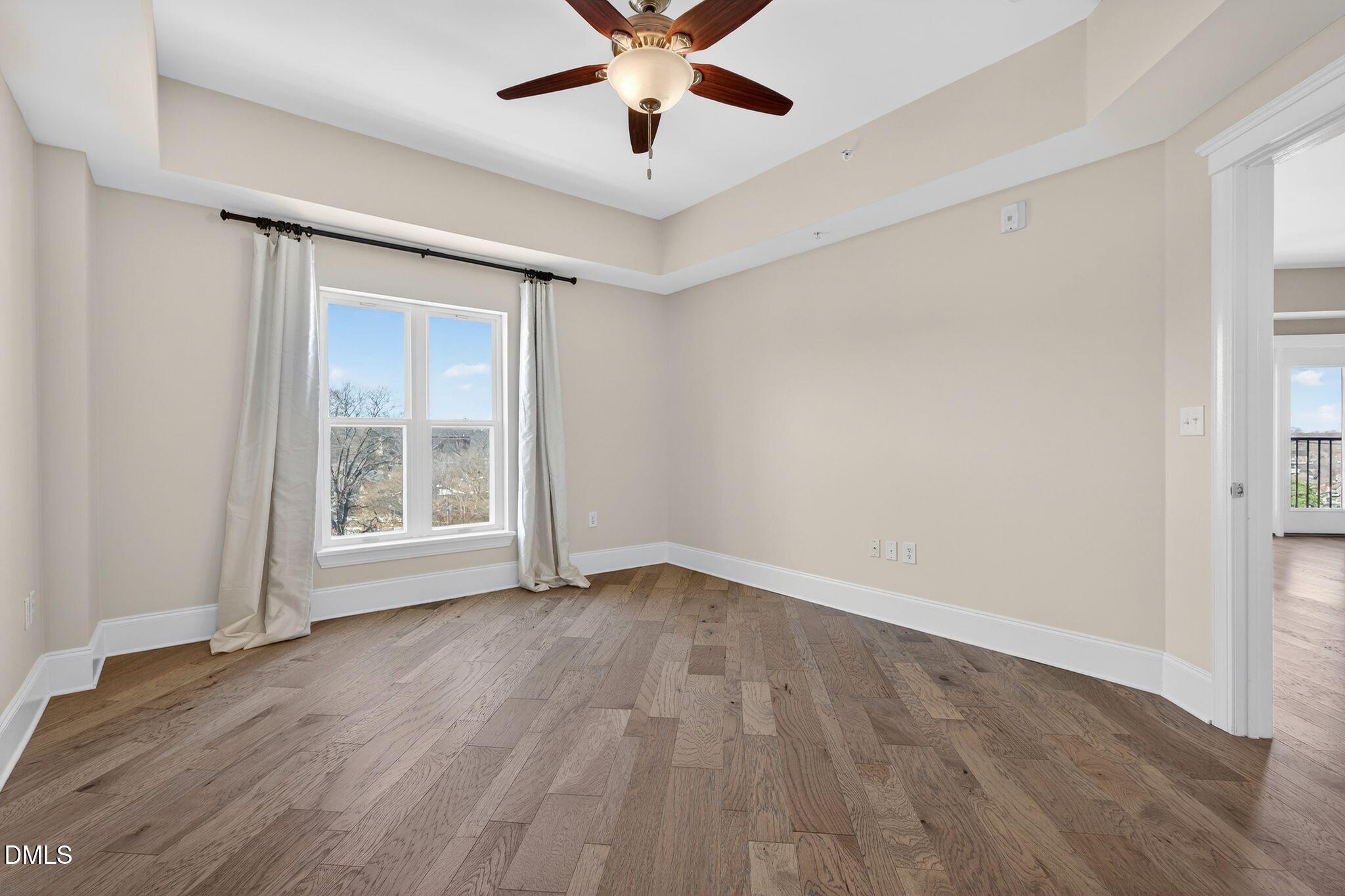 222 Glenwood Avenue, Unit 605 Raleigh, NC 27603 - Photo 24 of 60 wooden floor in an empty room with a window
