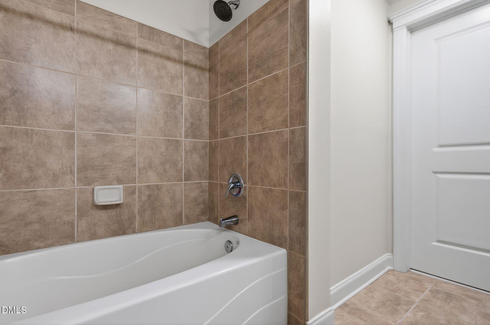 222 Glenwood Avenue, Unit 605 Raleigh, NC 27603 - Photo 26 of 60 a bathroom with a bathtub and a shower