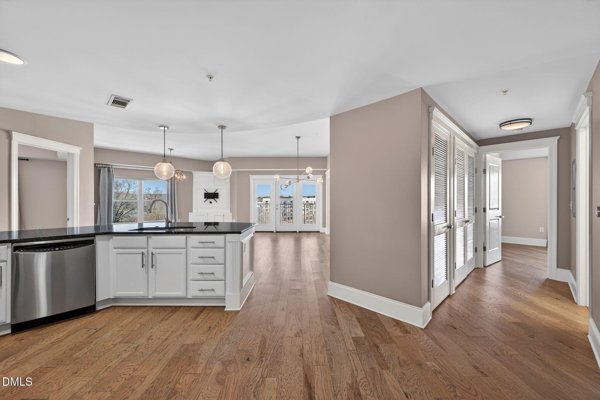 222 Glenwood Avenue, Unit 605 Raleigh, NC 27603 - Photo 28 of 60 a kitchen with granite countertop a refrigerator stove top oven and sink