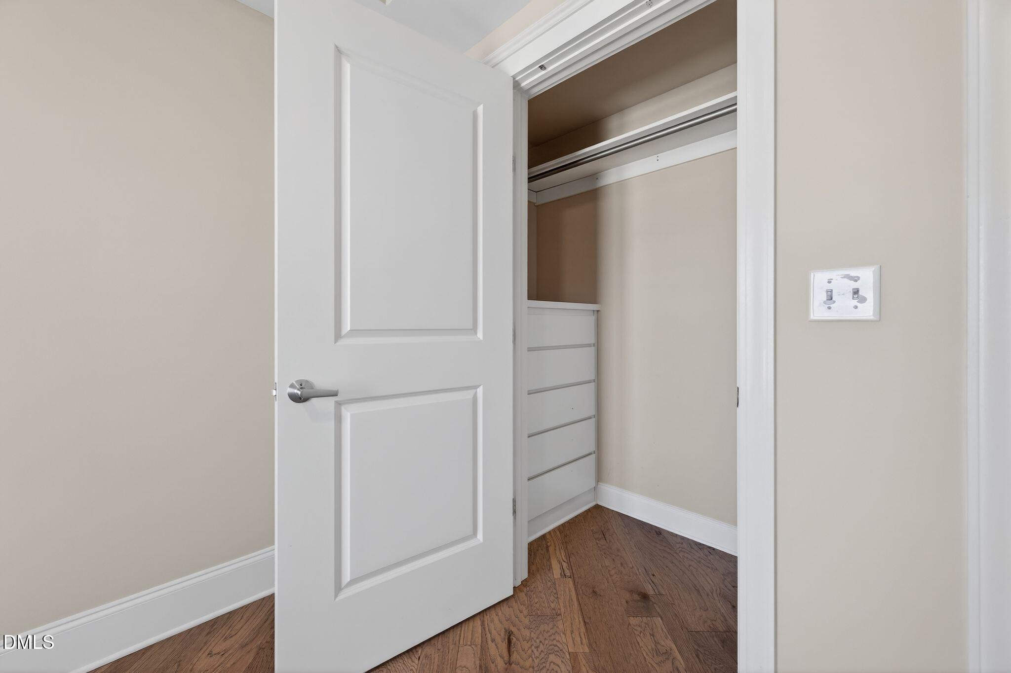 222 Glenwood Avenue, Unit 605 Raleigh, NC 27603 - Photo 33 of 60 a view of walk in closet with empty racks