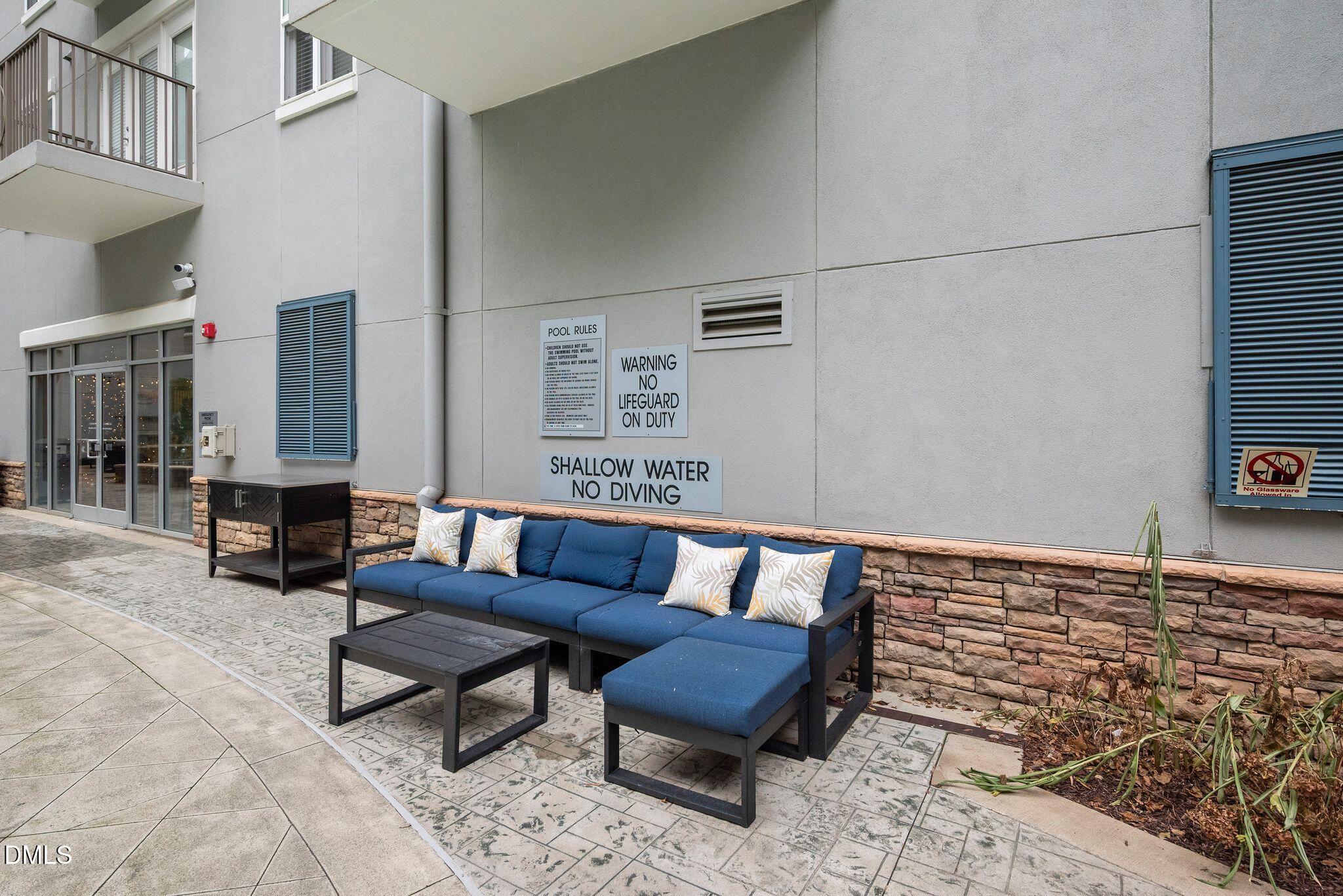 222 Glenwood Avenue, Unit 605 Raleigh, NC 27603 - Photo 39 of 60 a living room with furniture and a couch