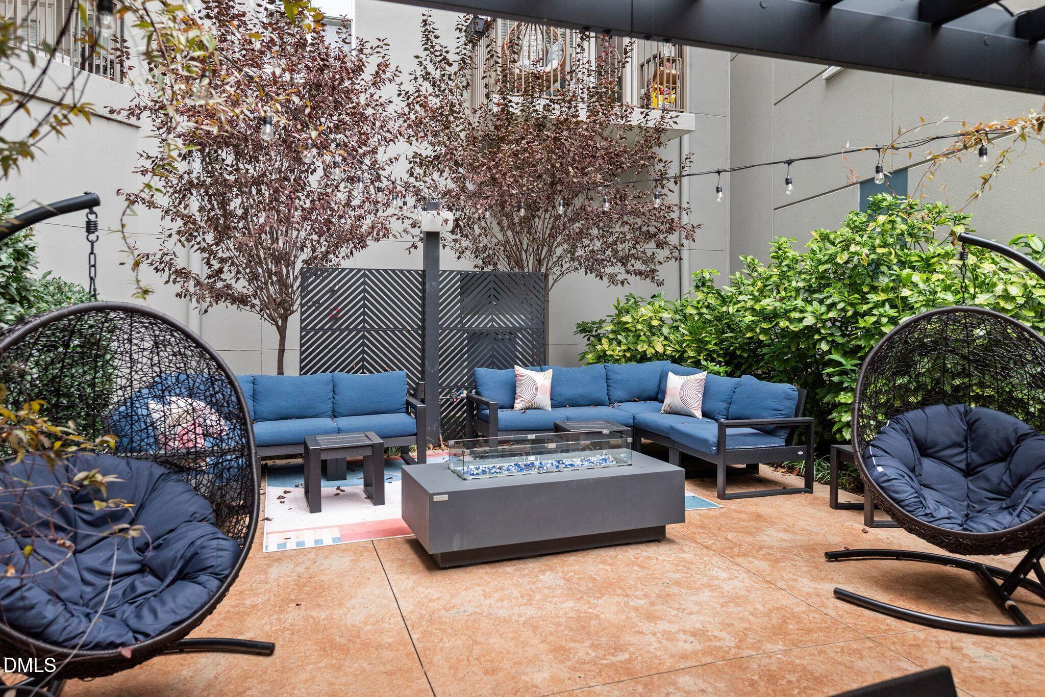 222 Glenwood Avenue, Unit 605 Raleigh, NC 27603 - Photo 41 of 60 a view of a patio with couches table and chairs and potted plants
