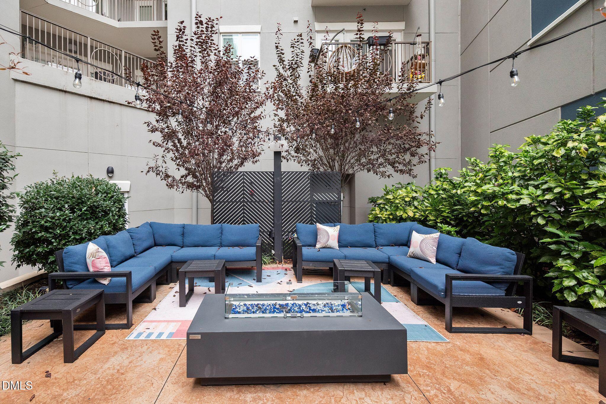 222 Glenwood Avenue, Unit 605 Raleigh, NC 27603 - Photo 42 of 60 a view of a patio with couches and a potted plant on a table