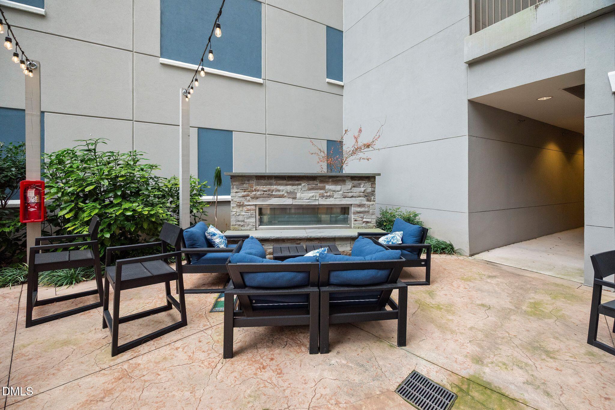 222 Glenwood Avenue, Unit 605 Raleigh, NC 27603 - Photo 43 of 60 a living room with furniture and a potted plant