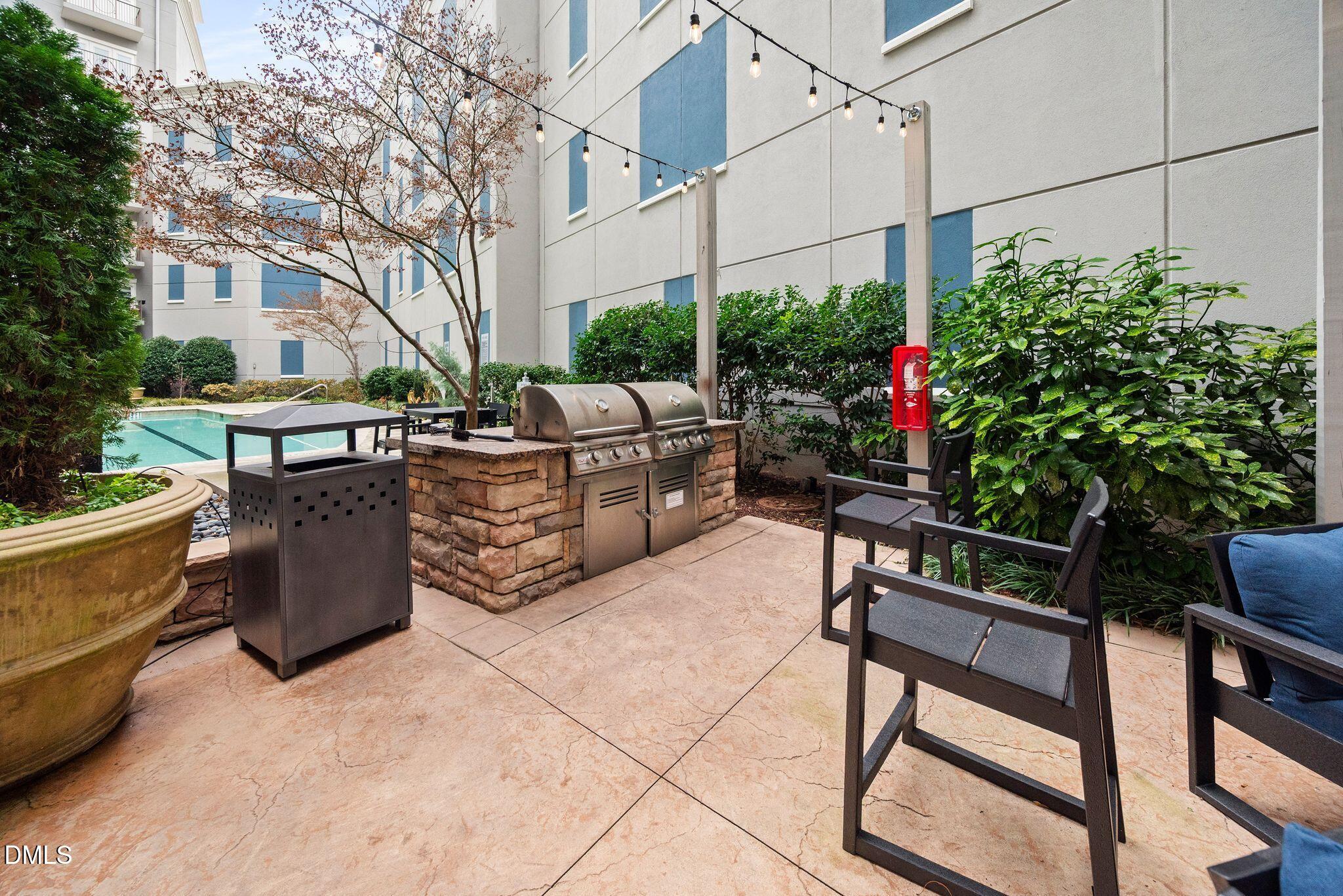 222 Glenwood Avenue, Unit 605 Raleigh, NC 27603 - Photo 44 of 60 a view of a patio with couches and potted plants