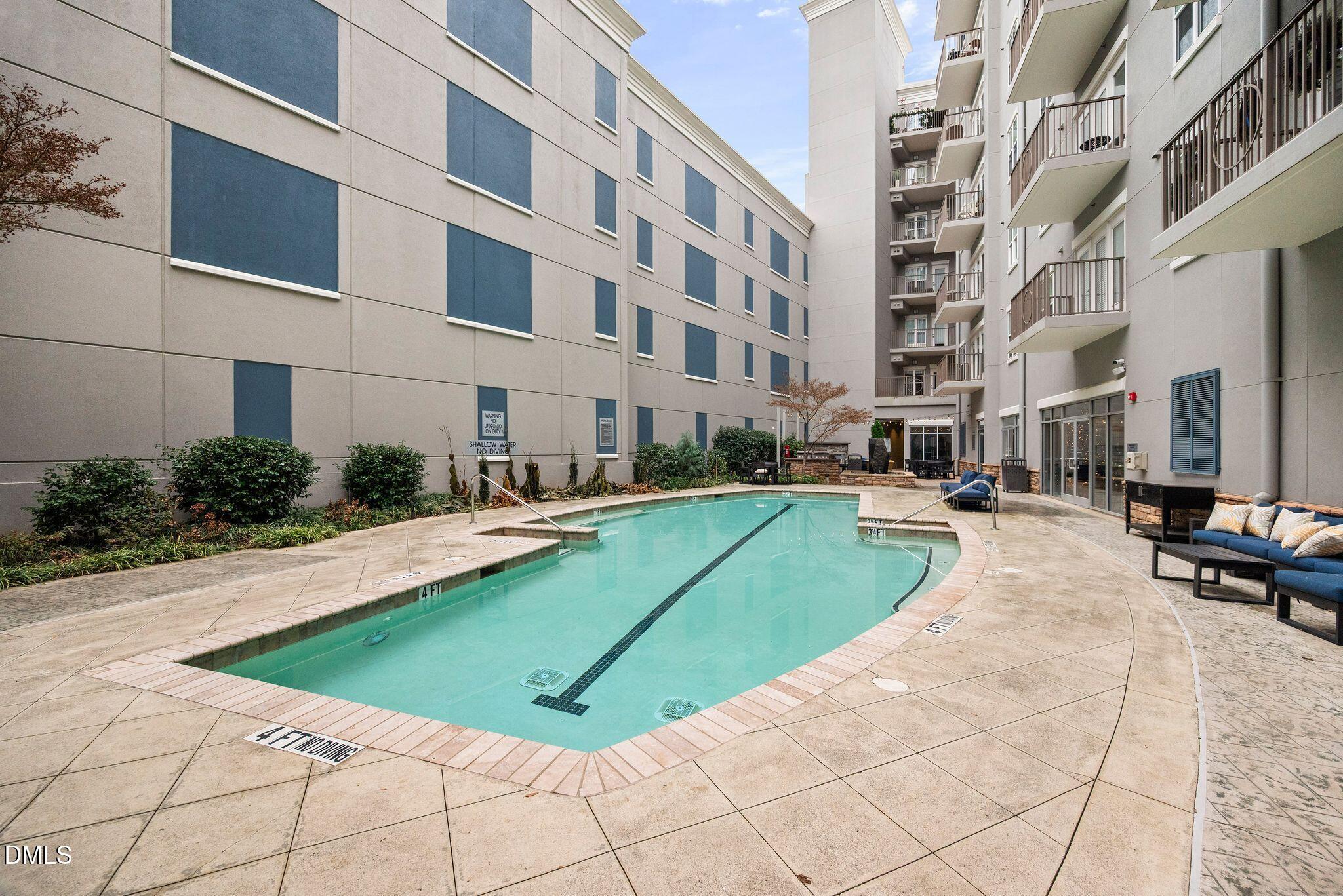 222 Glenwood Avenue, Unit 605 Raleigh, NC 27603 - Photo 45 of 60 a view of a swimming pool with a lounge chair