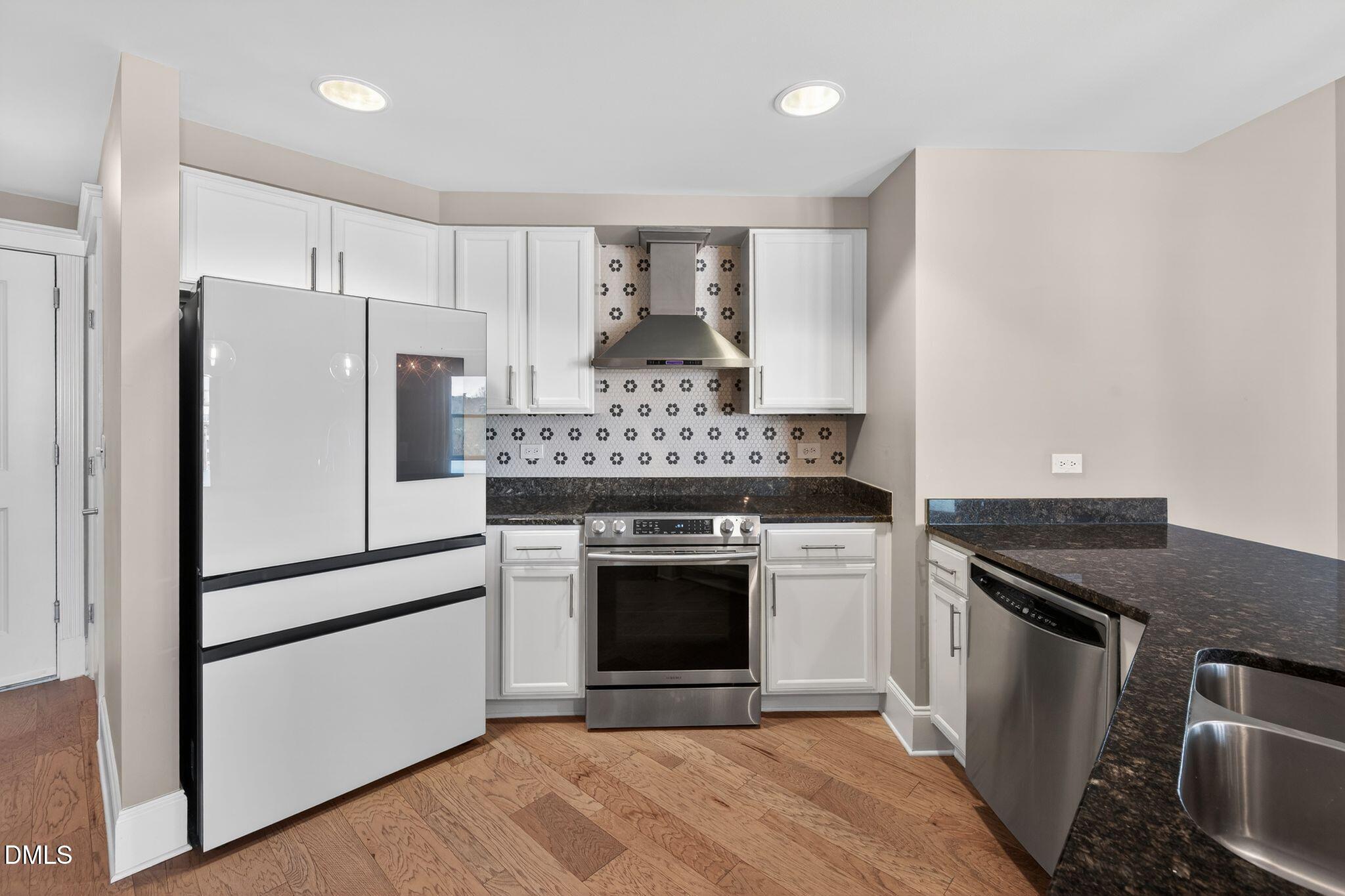 222 Glenwood Avenue, Unit 605 Raleigh, NC 27603 - Photo 4 of 60 a kitchen with a stove and a refrigerator