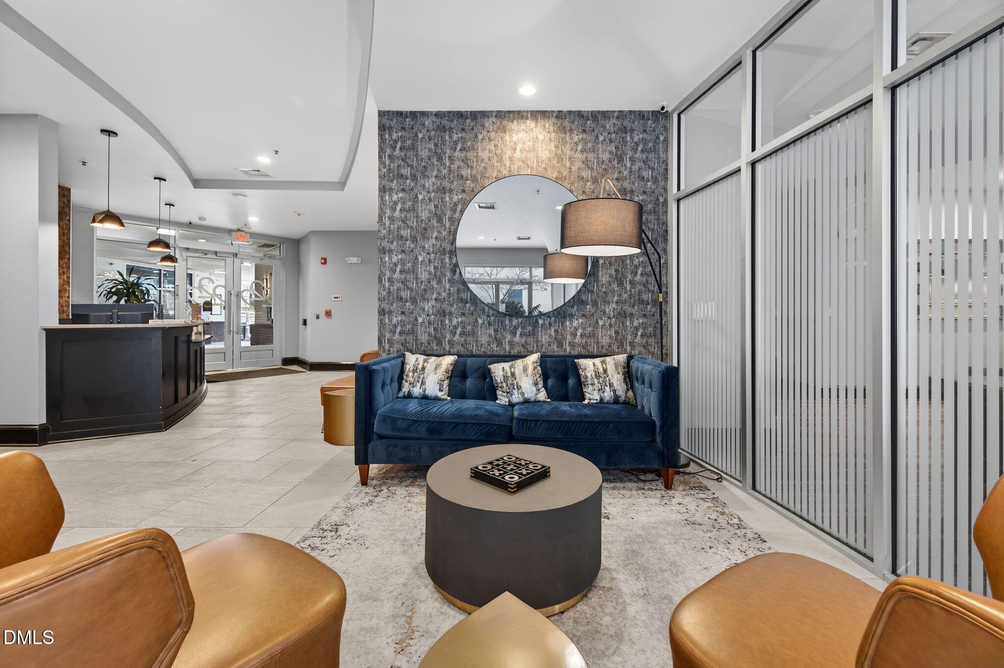 222 Glenwood Avenue, Unit 605 Raleigh, NC 27603 - Photo 52 of 60 a living room with furniture and a wooden floor