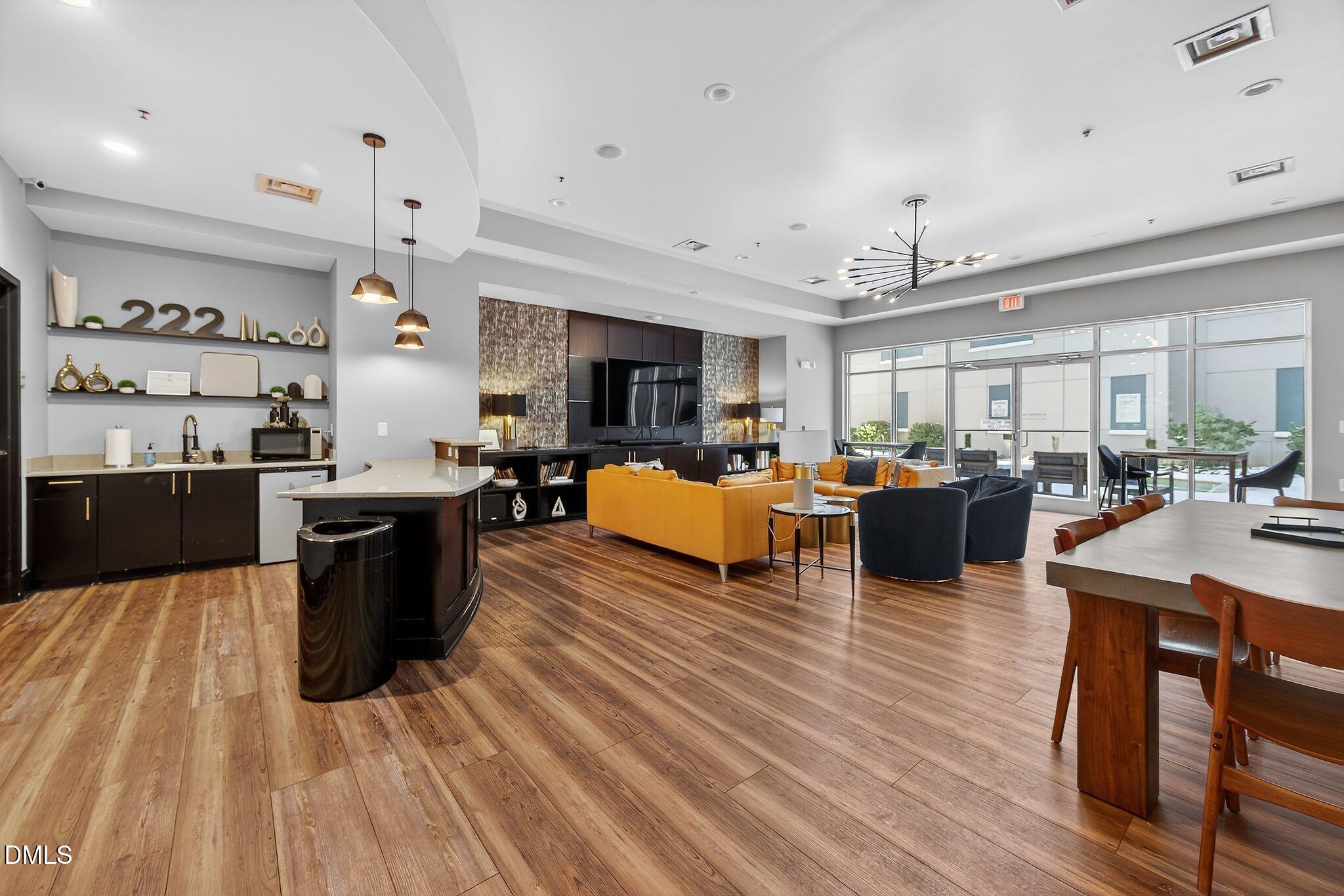 222 Glenwood Avenue, Unit 605 Raleigh, NC 27603 - Photo 55 of 60 a large room with lots of furniture and a wooden floor
