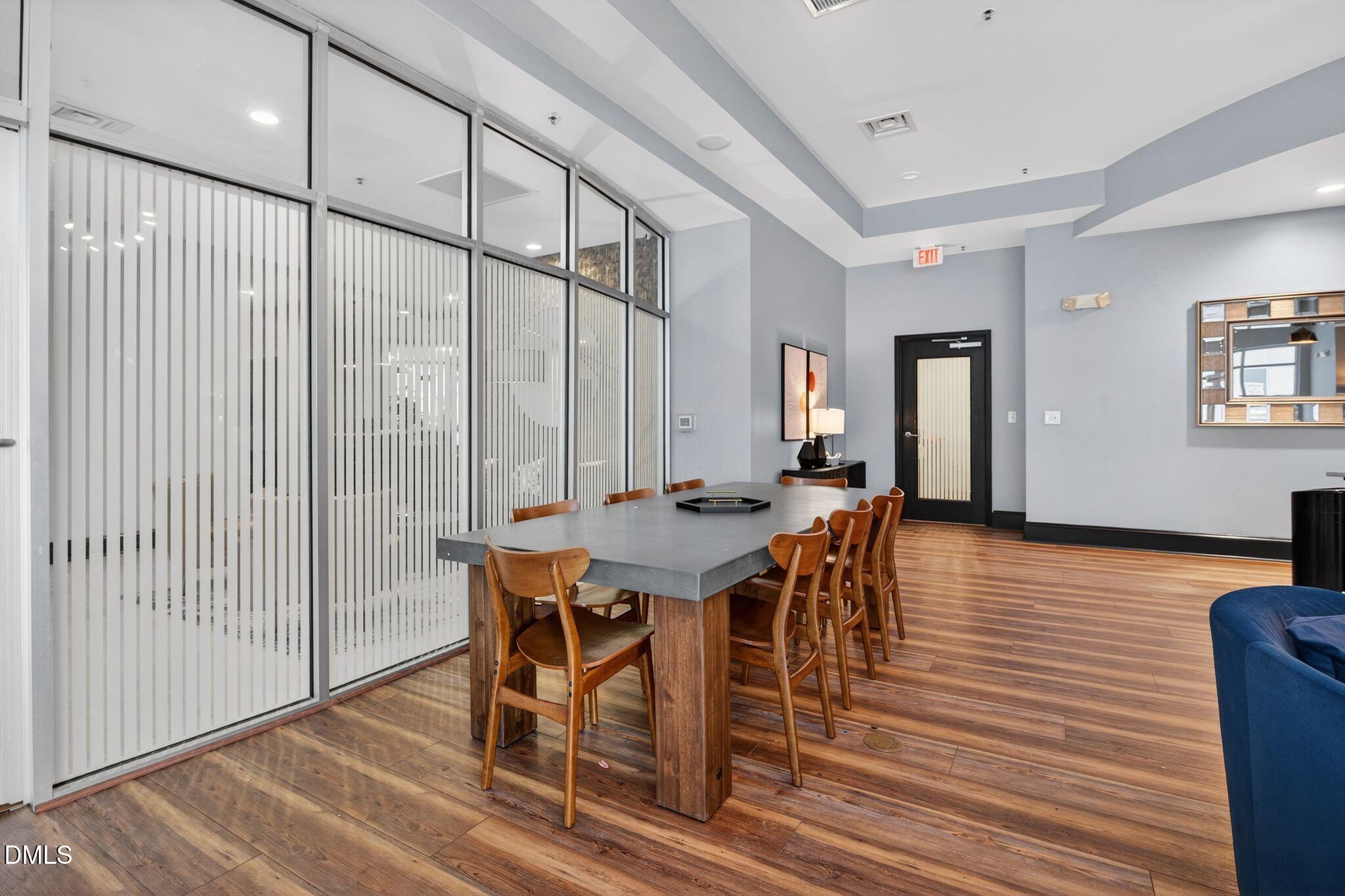 222 Glenwood Avenue, Unit 605 Raleigh, NC 27603 - Photo 58 of 60 a view of a dining room with furniture and wooden floor