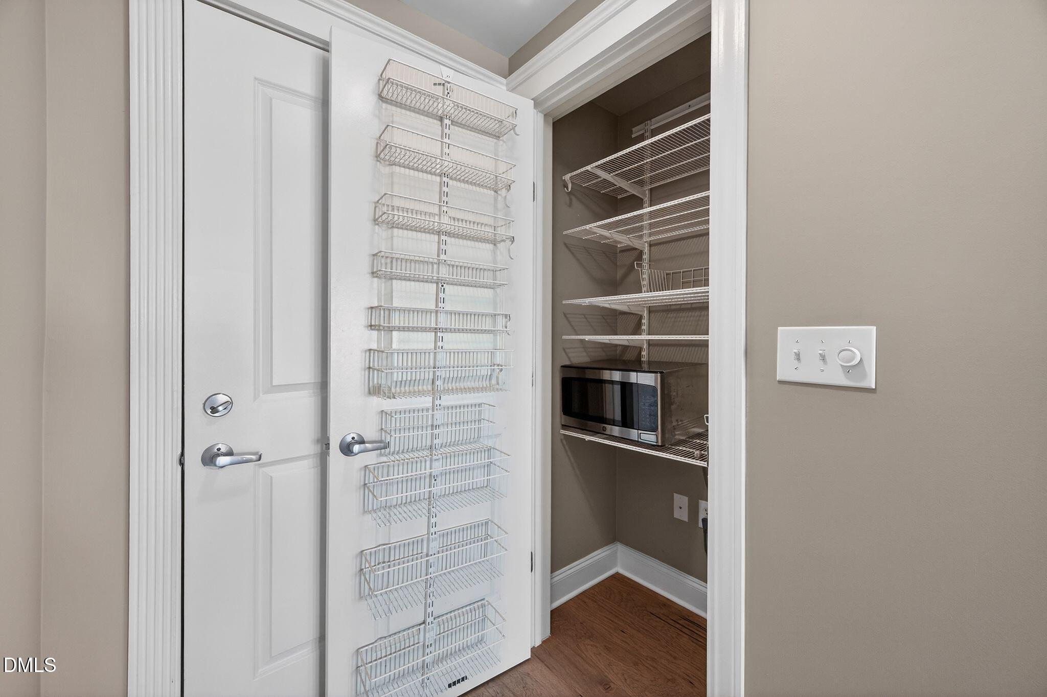 222 Glenwood Avenue, Unit 605 Raleigh, NC 27603 - Photo 5 of 60 a view of a refrigerator in kitchen and an empty room