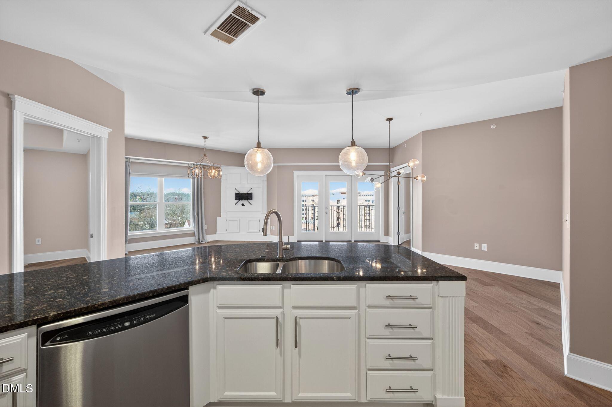 222 Glenwood Avenue, Unit 605 Raleigh, NC 27603 - Photo 7 of 60 a kitchen with a counter space cabinets and a window