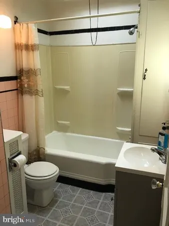 a bathroom with a toilet a sink and bathtub