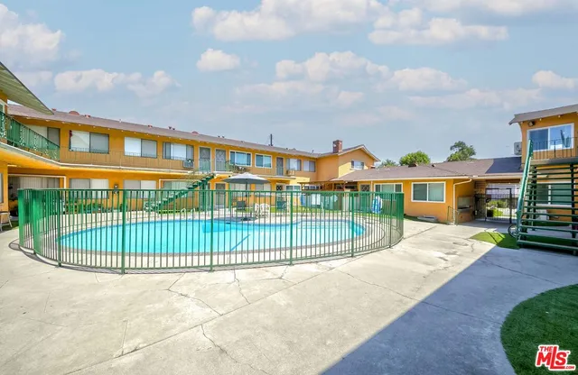 a view of a brick building next to a yard