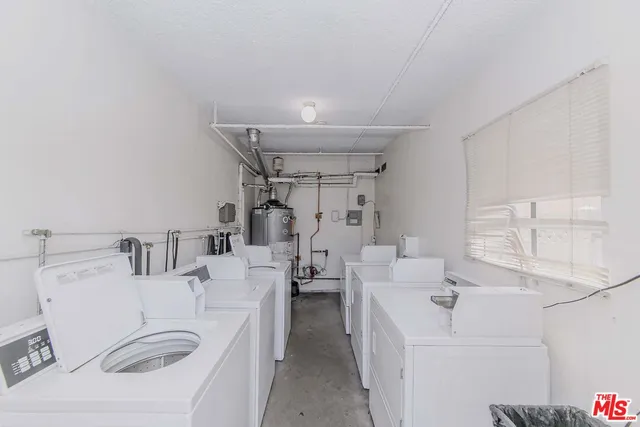 a room with a sink washer and dryer