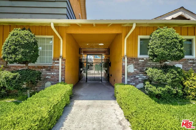 a view of a house with potted plants