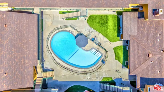 an aerial view of a swimming pool and outdoor space
