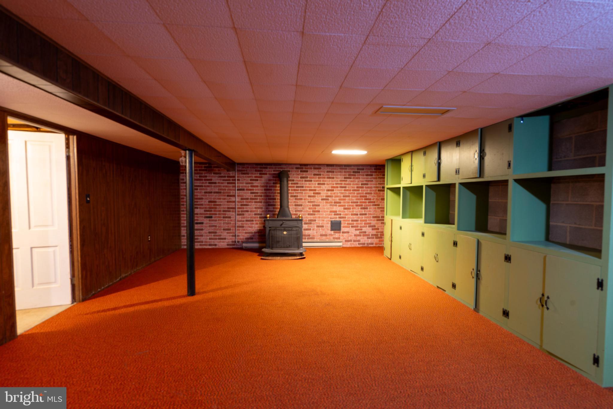 915 Trevanion Road Union Bridge, MD 21791 - Photo 27 of 44 Finished basement area, wood stove