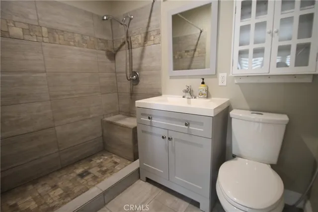 a bathroom with a sink toilet and a mirror