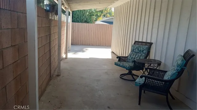 a view of balcony with wooden bench