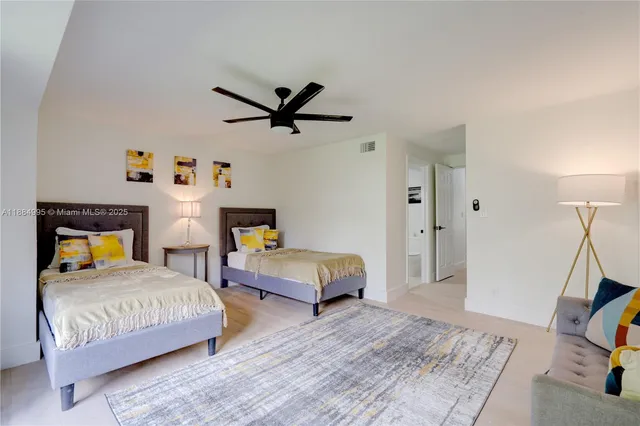 a bedroom with a bed a couch and a window