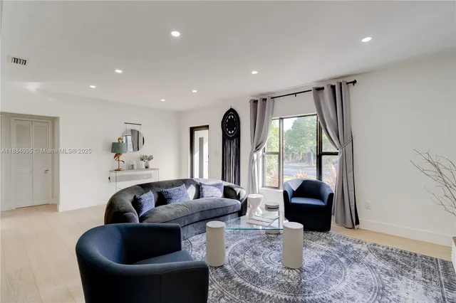 a living room with furniture and a large window