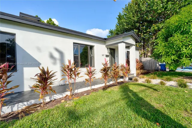 a view of backyard with swimming pool and outdoor seating